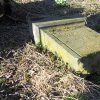 Žalmanov - Mertelův kříž | poškozený pískovcový podstavec Mertelova kříže v zahradě domu čp. 47 v Žalmanově - březen 2017
